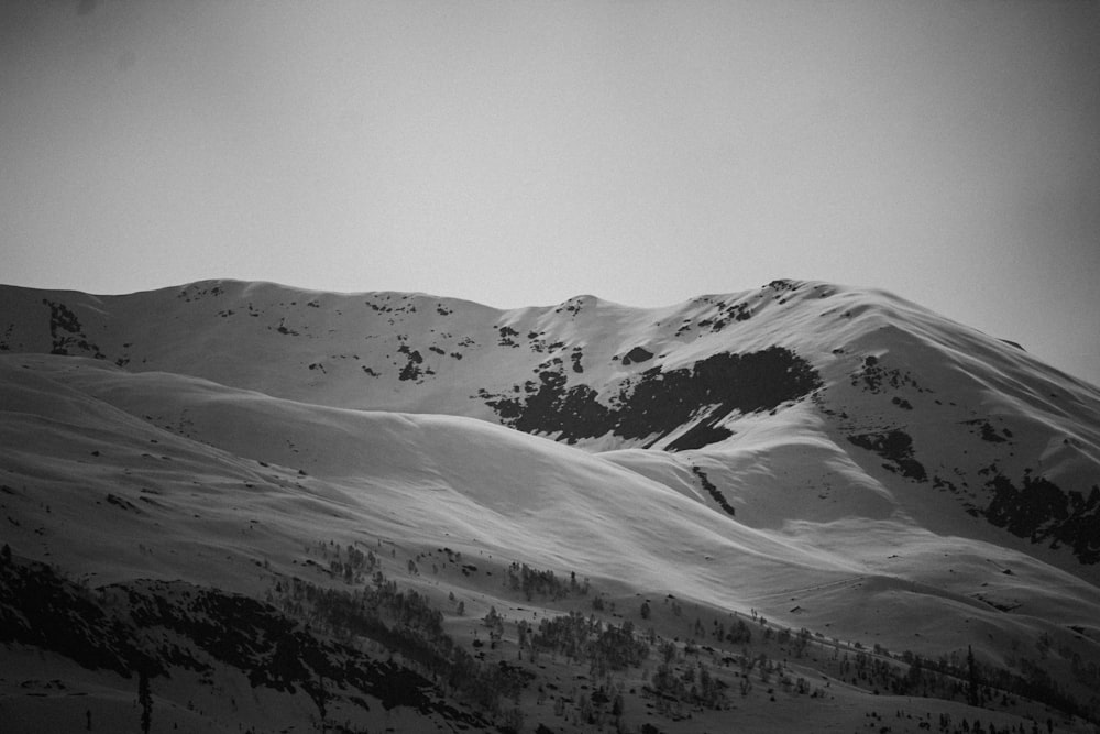 a black and white photo of a snowy mountain