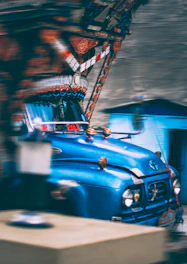 A colorful delivery van with pet-themed decorations driving through a vibrant Mexican town.