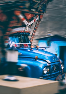 A bold truck wrap design featuring sharp lines and vibrant cyan highlights on a large freight truck.