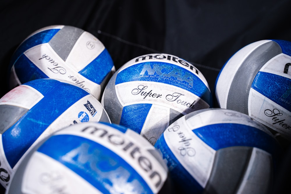 a pile of blue and white volleyballs sitting next to each other