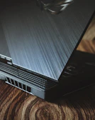 a laptop computer sitting on top of a wooden table