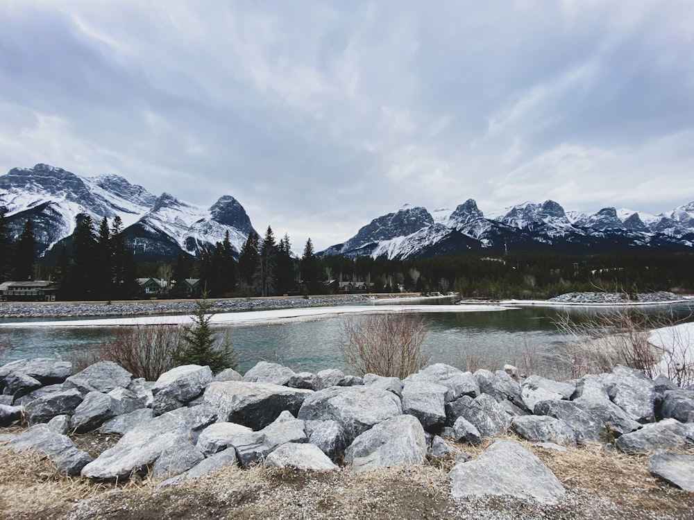 a mountain range with a body of water in the foreground