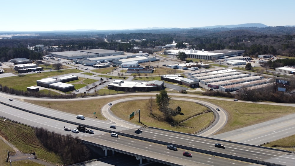 an aerial view of a highway intersection with cars driving on it