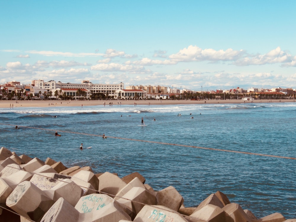 a view of a beach with people swimming in the water