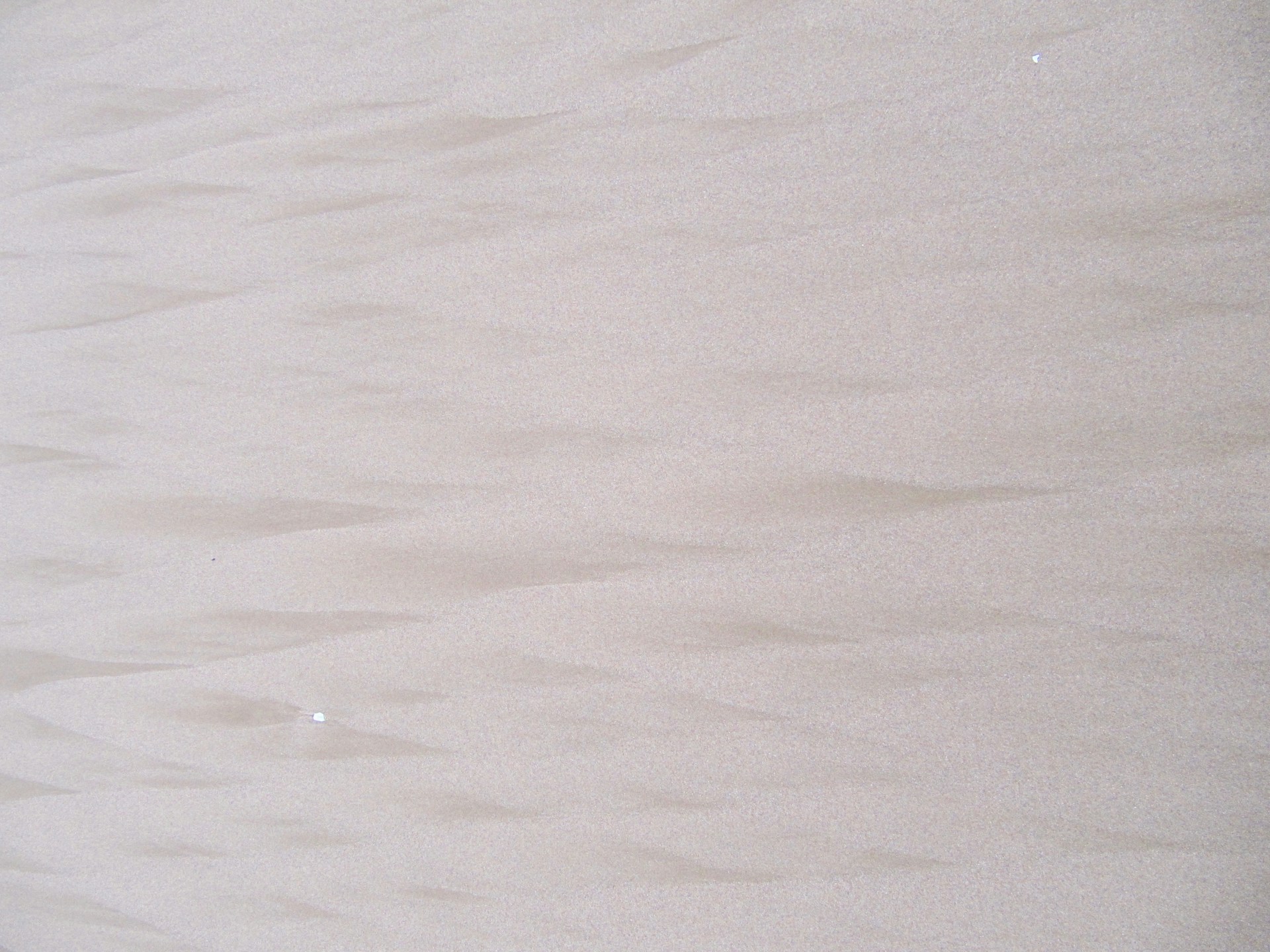 a man riding a surfboard on top of a wave covered beach