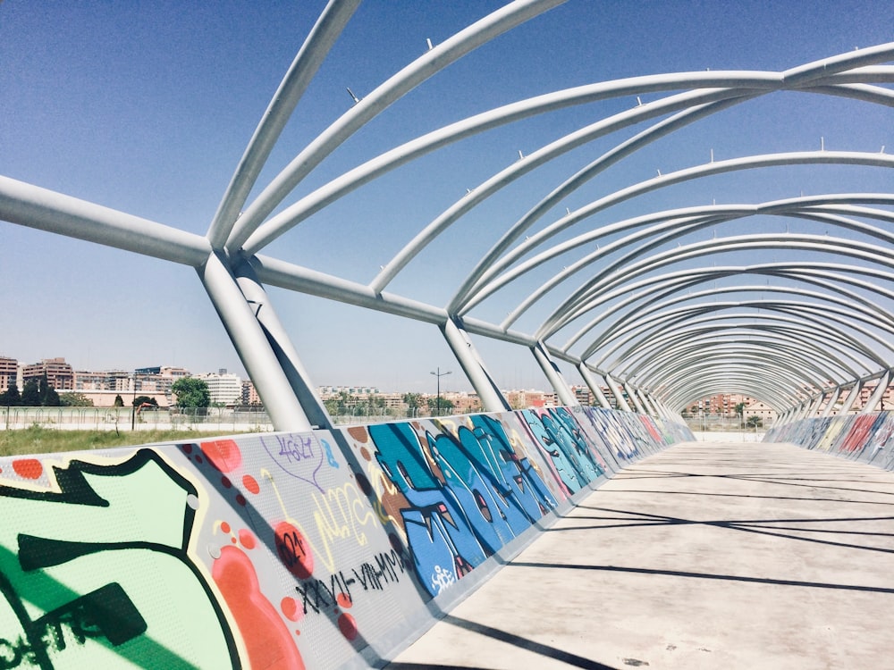 a bridge with graffiti on the side of it