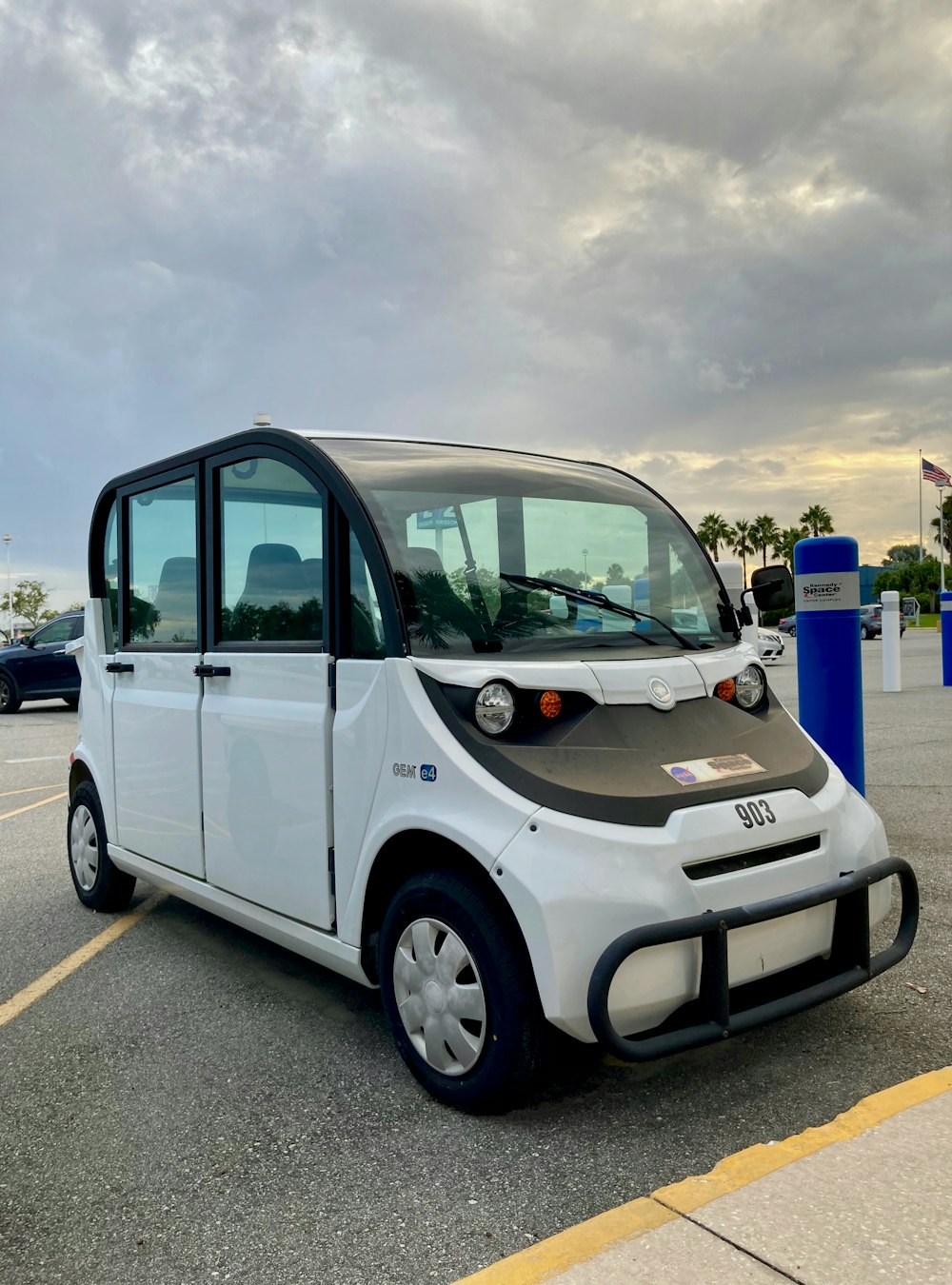 a small electric car parked in a parking lot