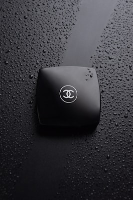 A waterproof travel pouch holding toiletries, with water droplets on the surface to highlight its moisture resistance.