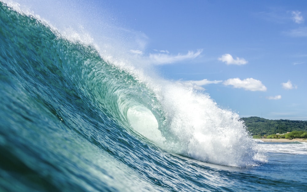 a large wave is coming towards the shore