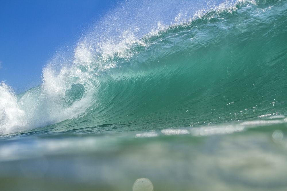 a man riding a wave on top of a surfboard