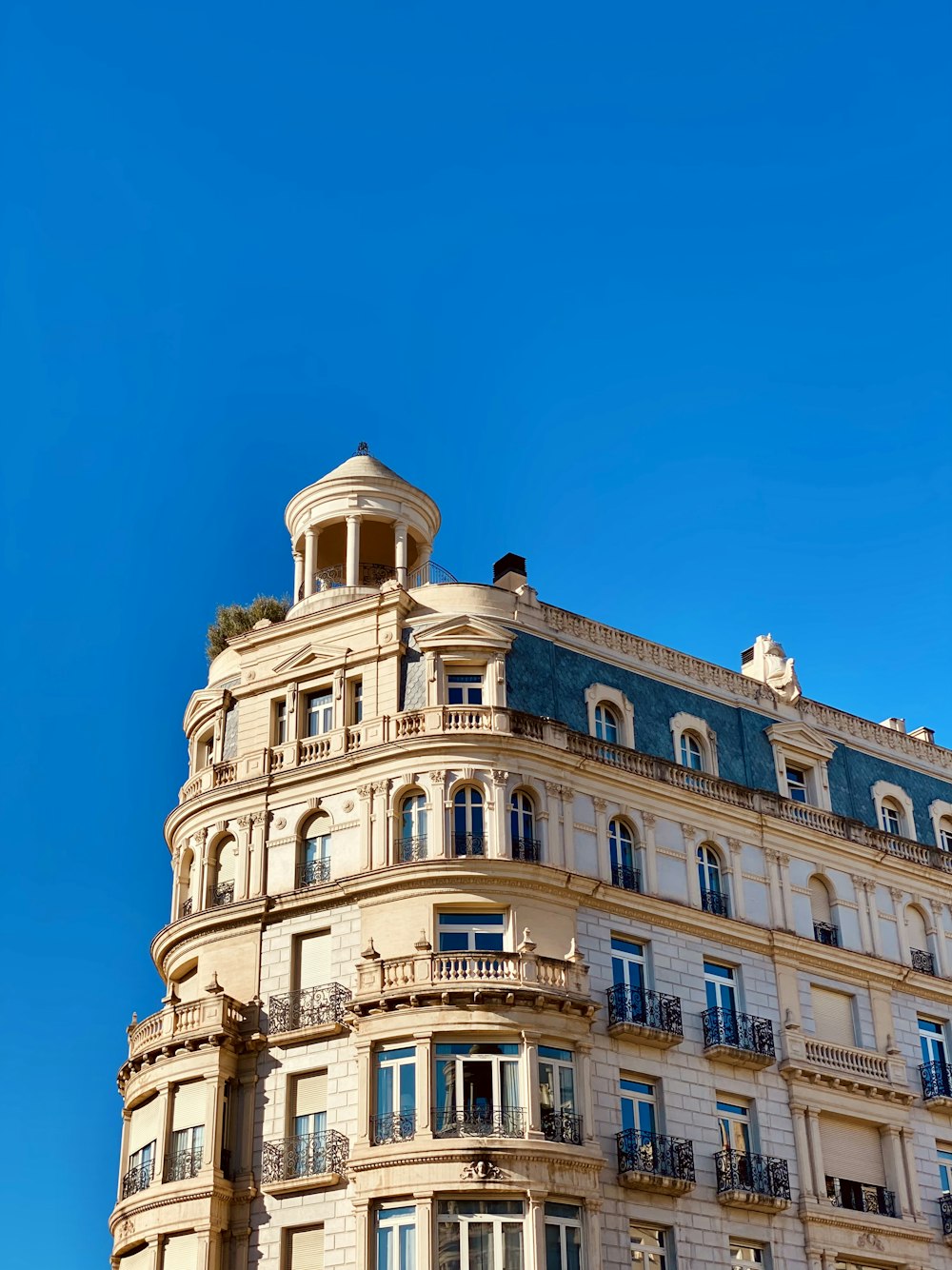 a tall building with balconies and balconies on the top of it