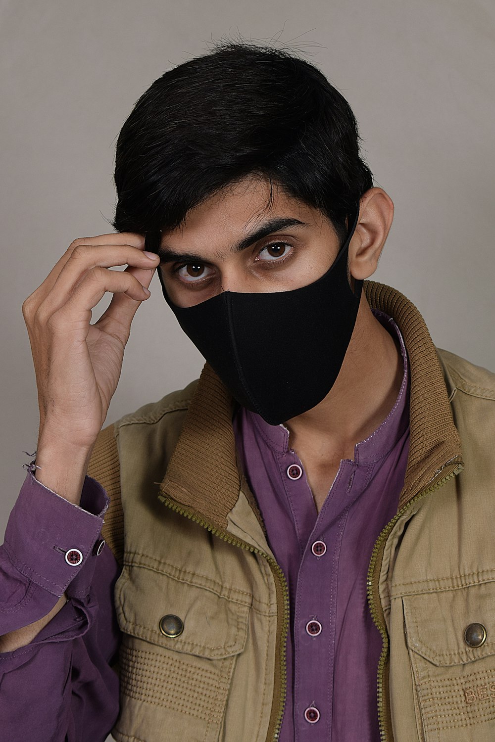 a man with a black mask covering his face