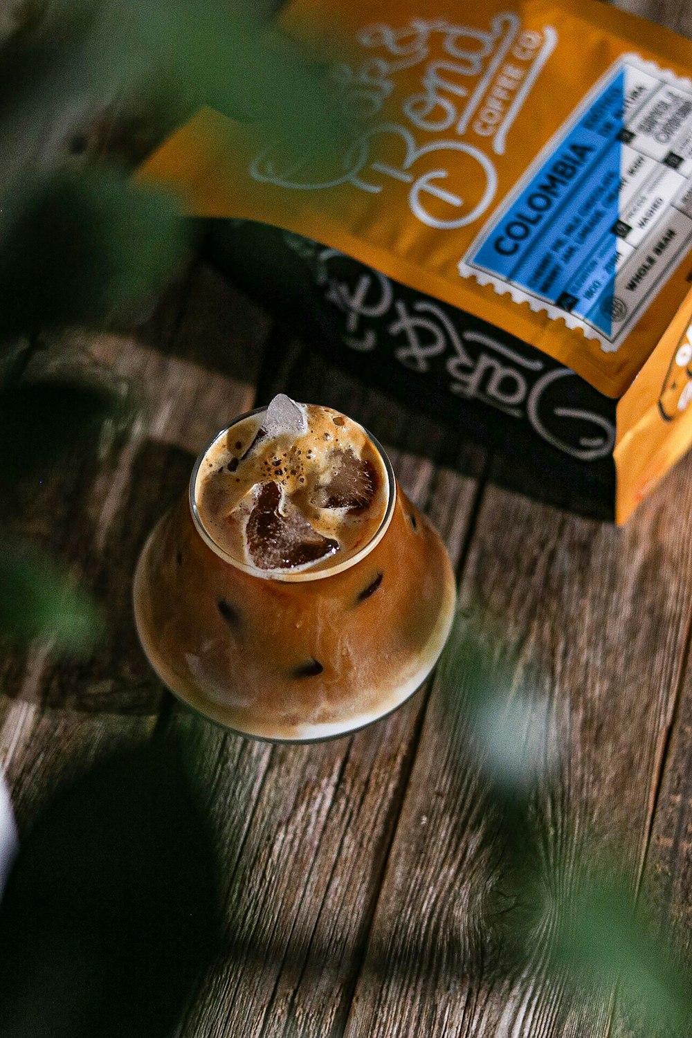 a cup of coffee sitting on top of a wooden table