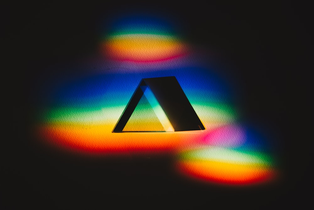 a triangle shaped object is shown in the dark