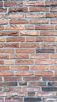a close up of a red brick wall