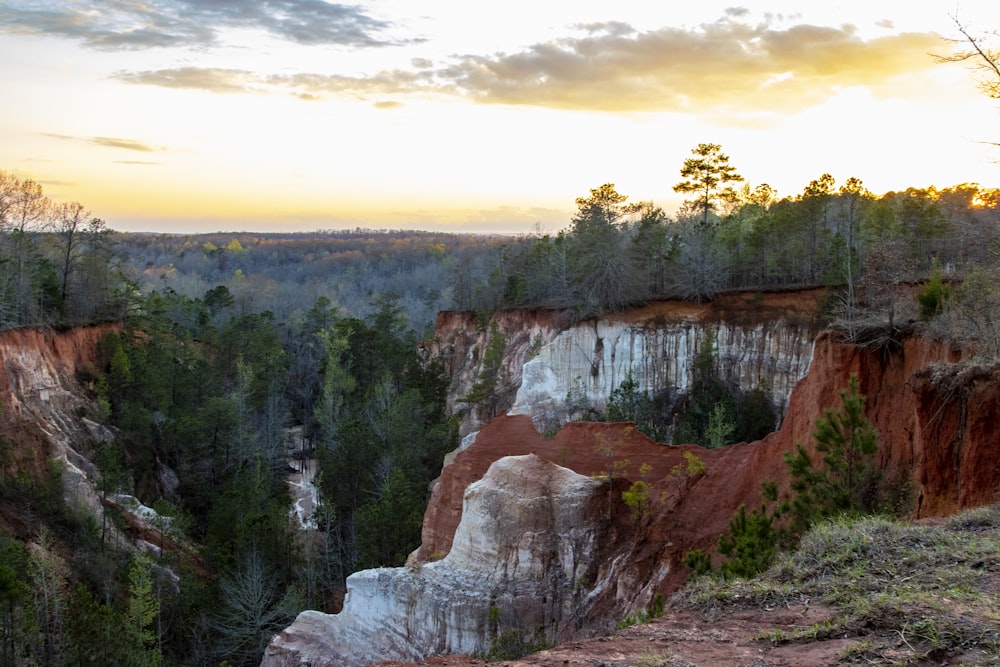 the sun is setting over the canyons and trees