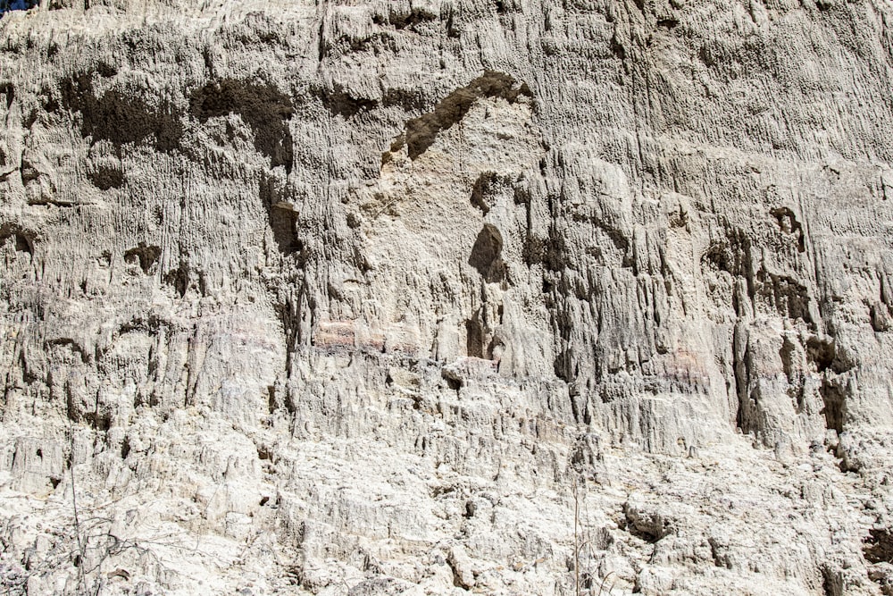 a close up of a rock face with a sky background