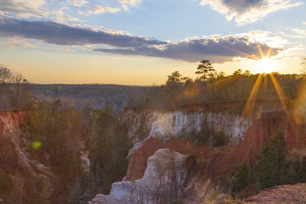 the sun is setting over a canyon in the mountains