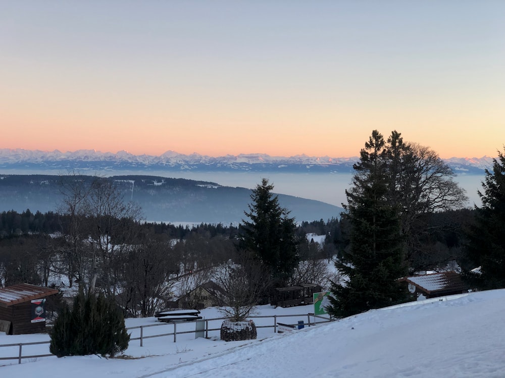 a view of a snowy mountain range at sunset