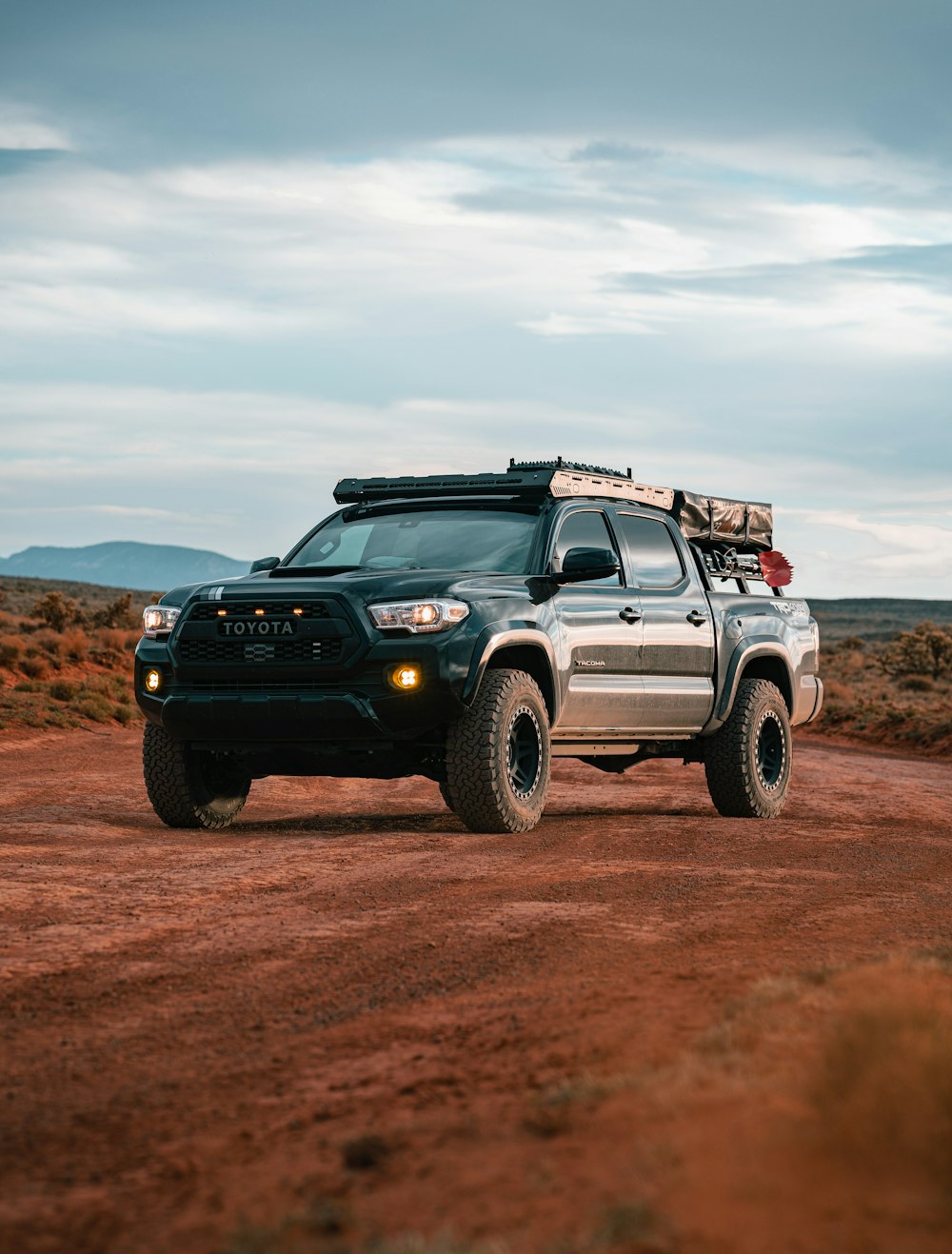 a truck is parked on a dirt road