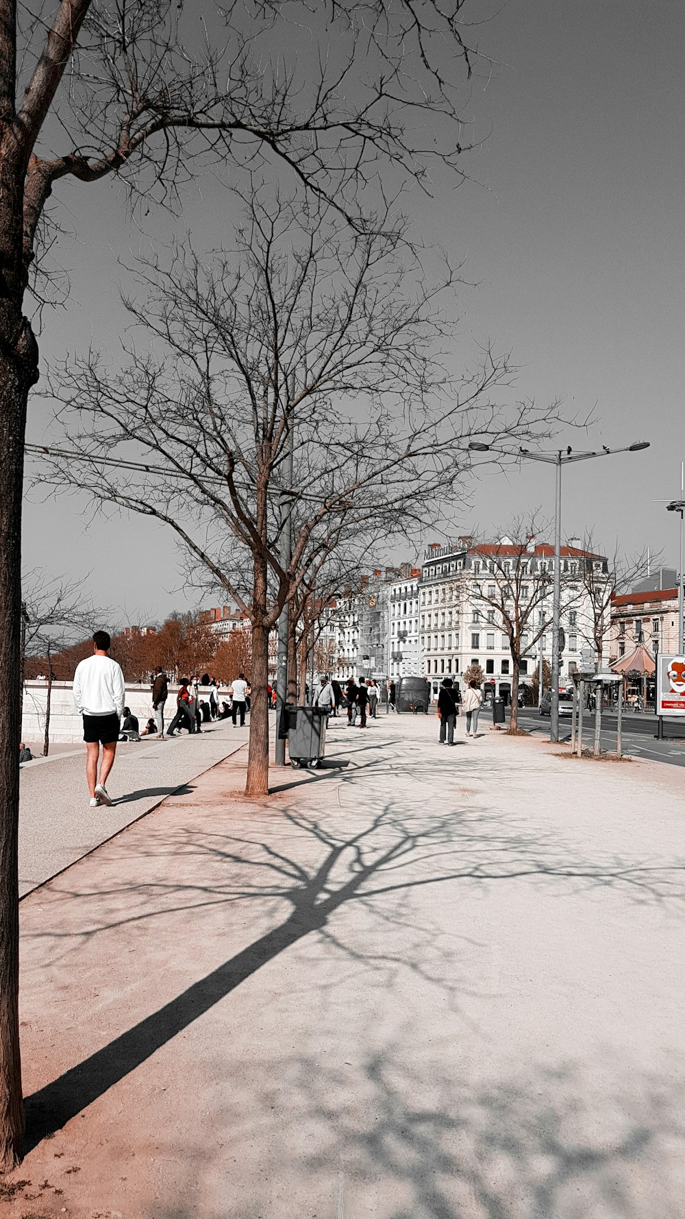 a black and white photo of people walking on a sidewalk