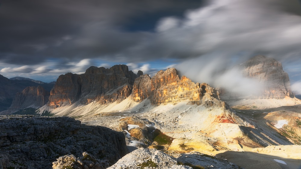 a view of a mountain range with clouds in the sky