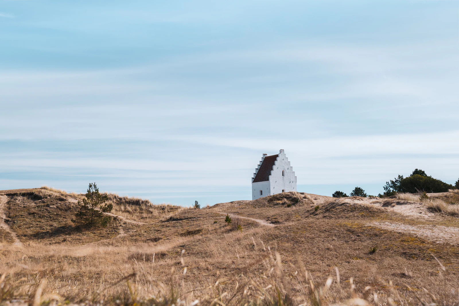 Sand-covered church stands in the dunes near Skagen