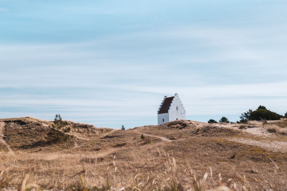 a white house sitting on top of a hill