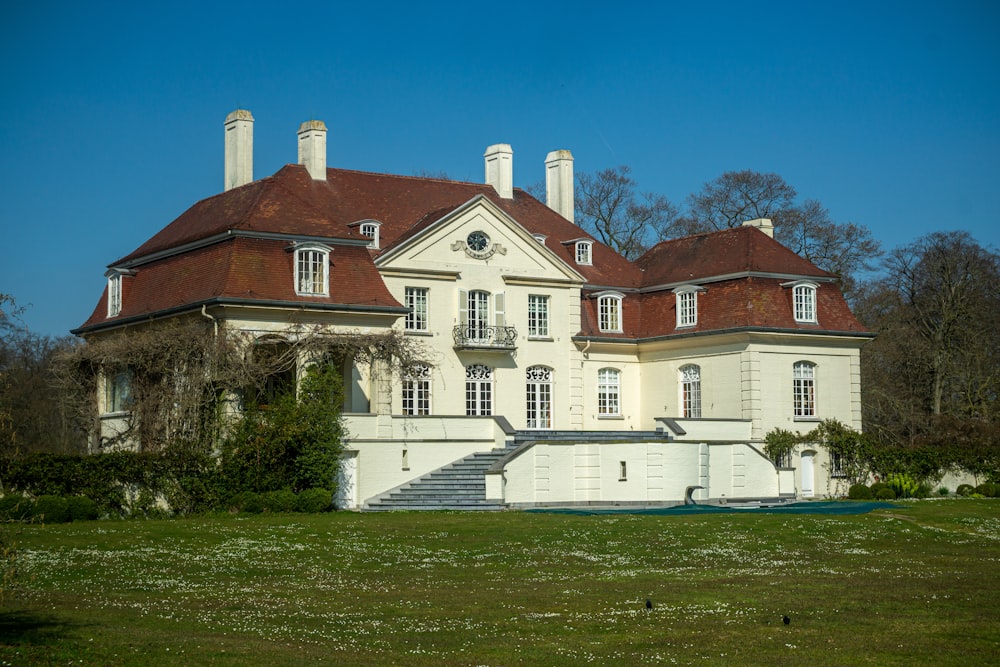 a large white house with a red roof