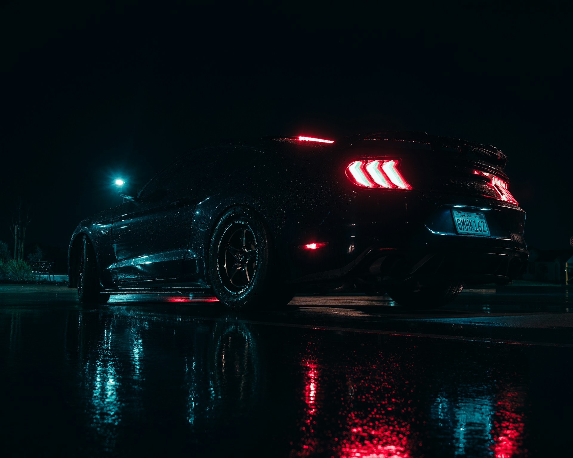 a car parked on the side of the road at night