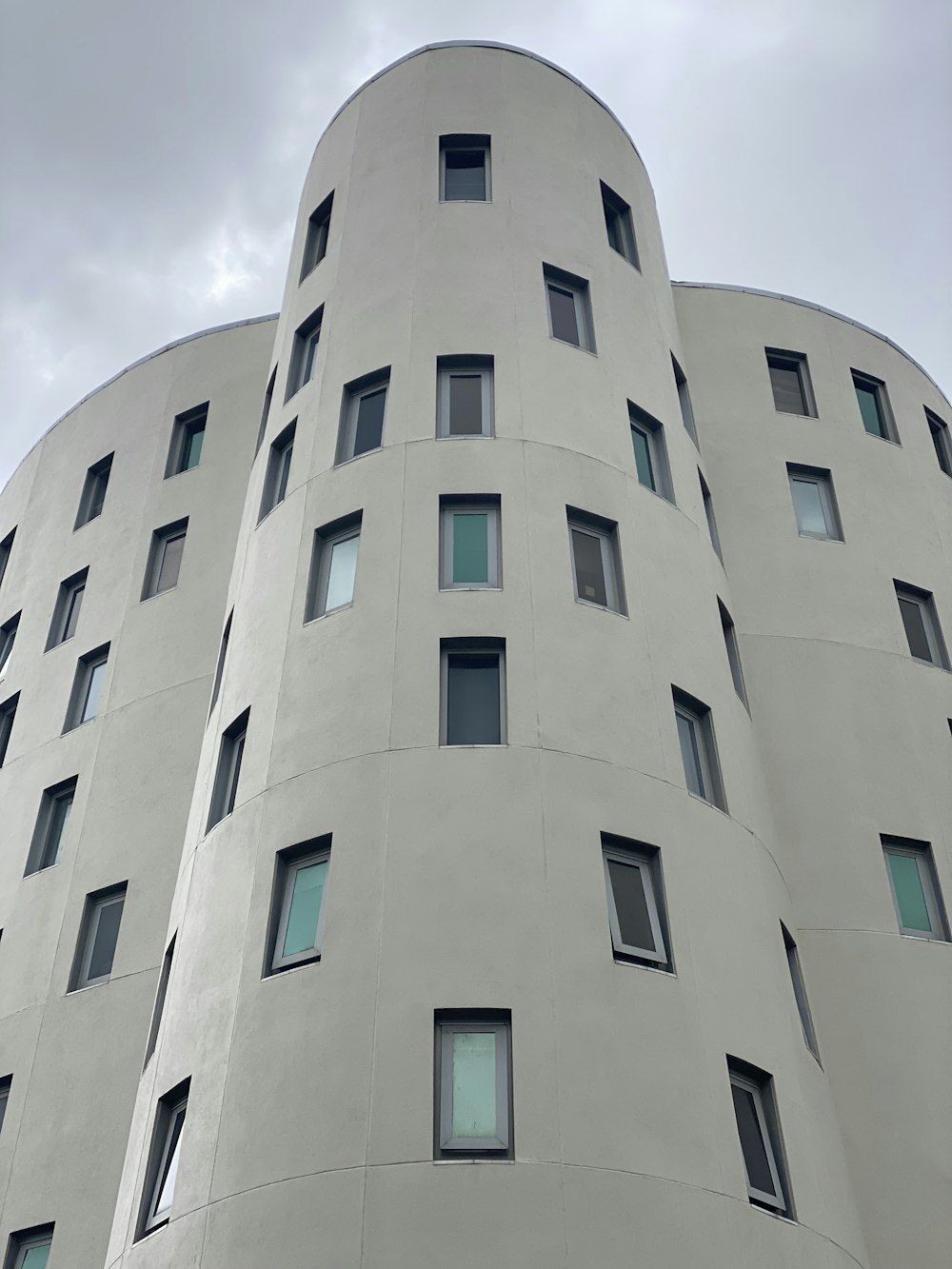 a tall white building with lots of windows