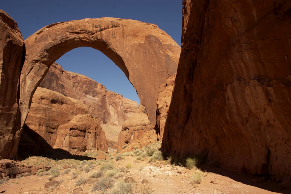 a large arch in the middle of a desert