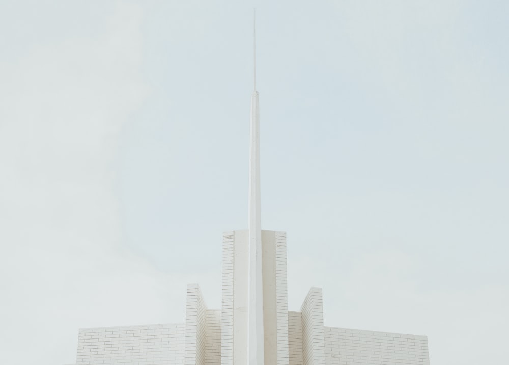 a tall white building with a flag on top of it