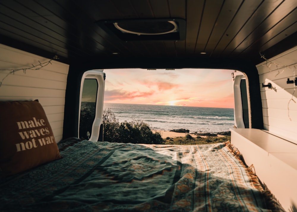 a bedroom with a bed and a view of the ocean