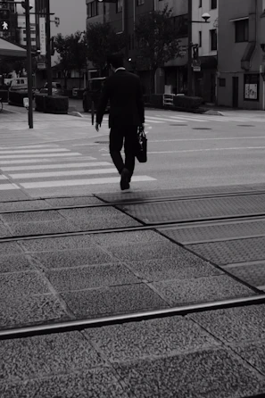 A Lexvita team member confidently walking through a busy city street with legal documents in hand.