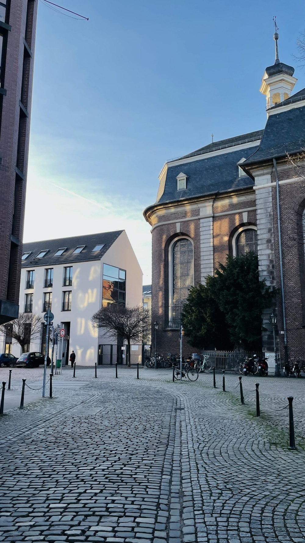 a cobblestone street with a church in the background