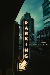 Minimalist icon set representing the four steps of the parking process in neon green on dark background.