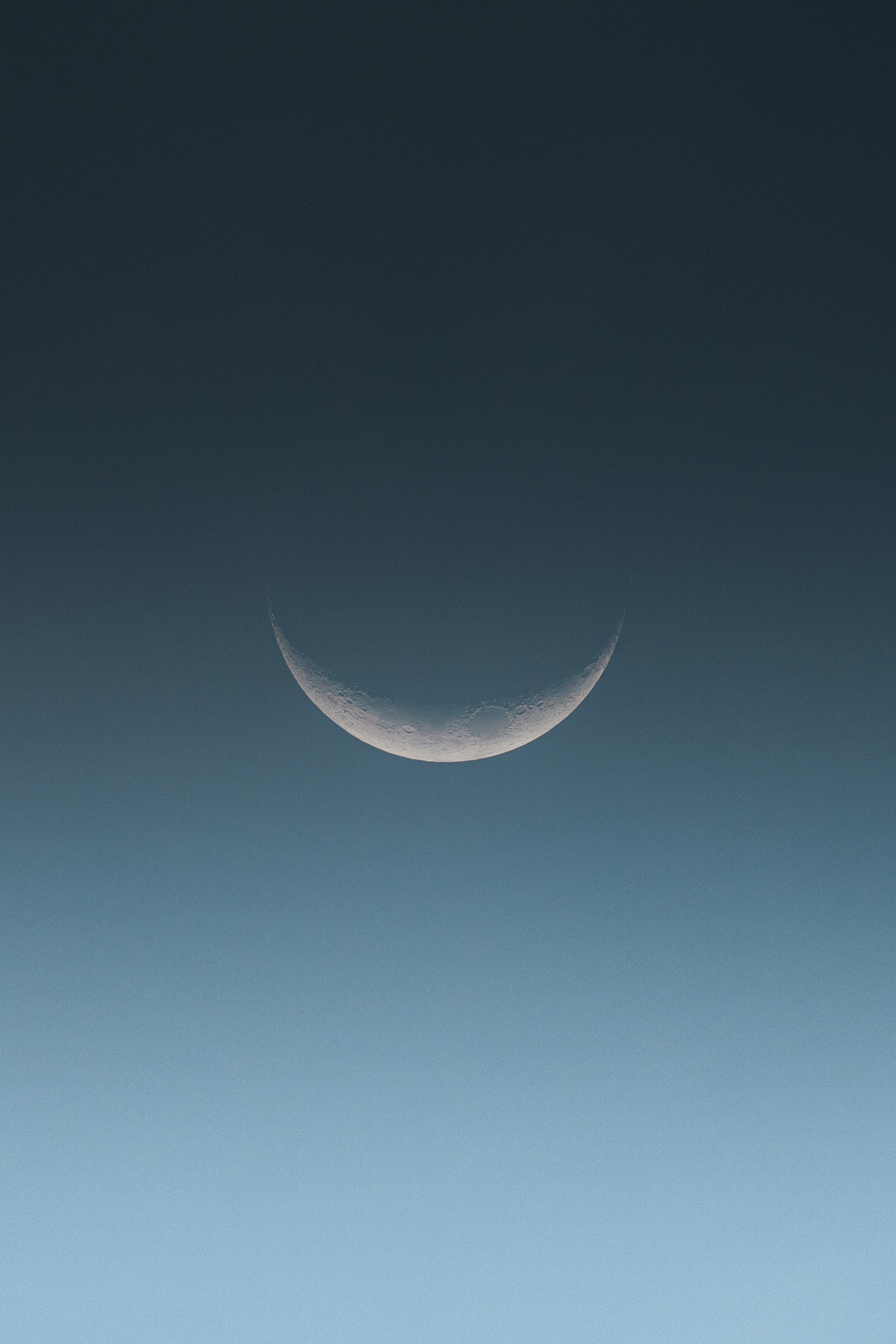 a crescent moon is seen in the sky