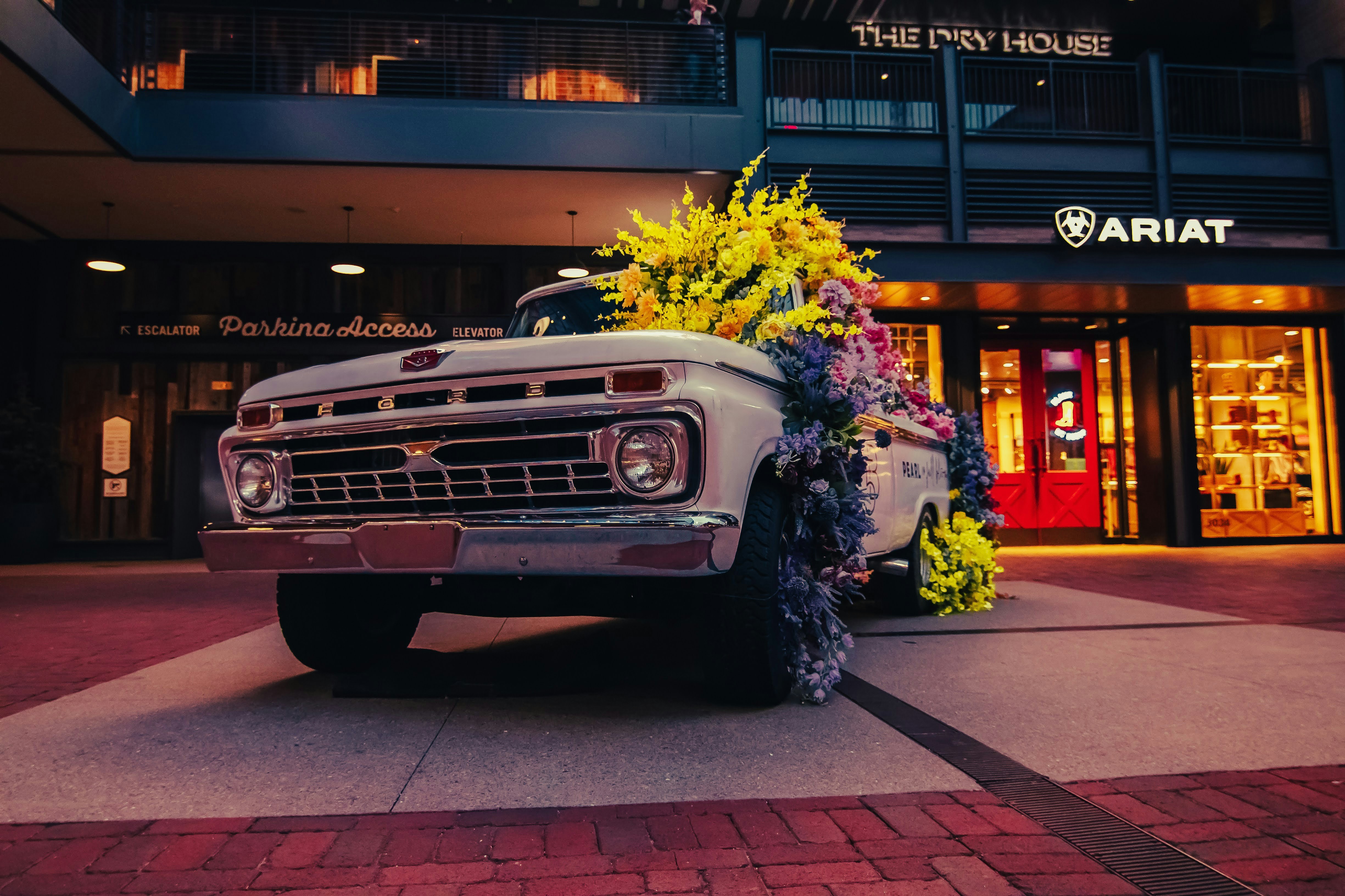 a truck with a bunch of flowers on the back of it