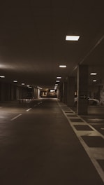 an empty parking garage at night with lights on