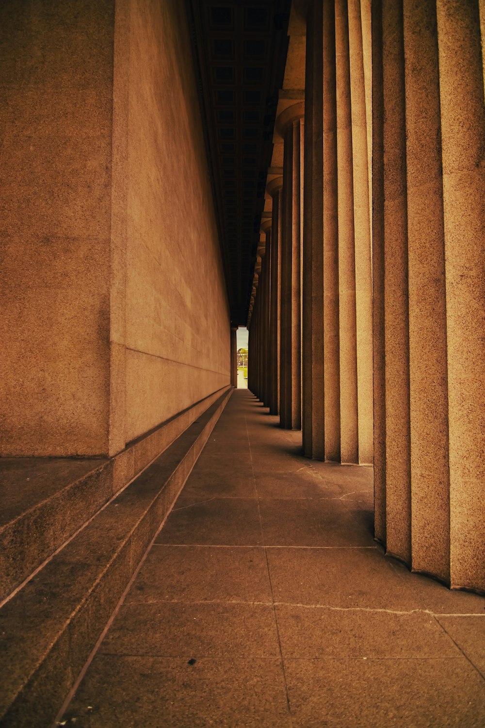 a long row of columns on the side of a building