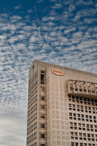 Denny Humphrey smiling confidently in front of a Houston commercial building.