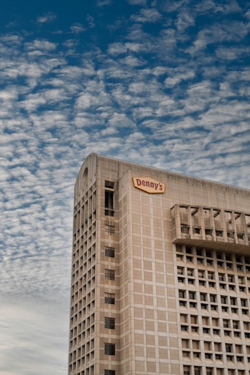 Denny Humphrey smiling confidently in front of a Houston commercial building.