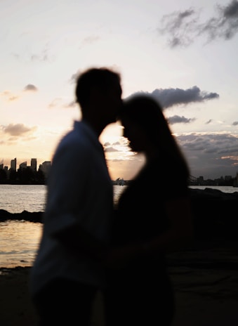 Happy couple enjoying a peaceful moment on deck with the Mumbai skyline in the background.