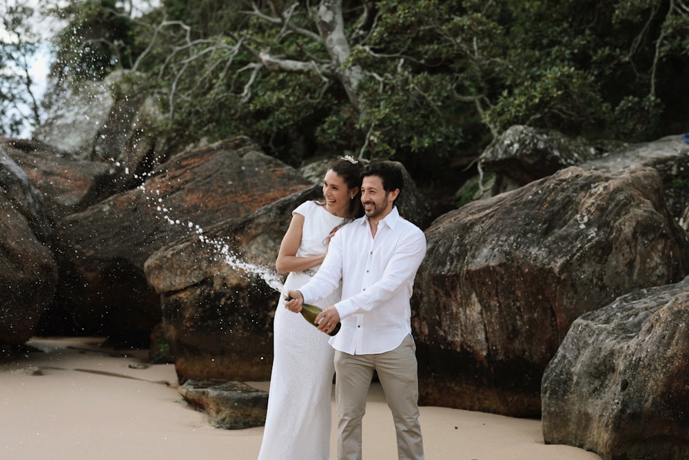 a man and a woman standing on a beach