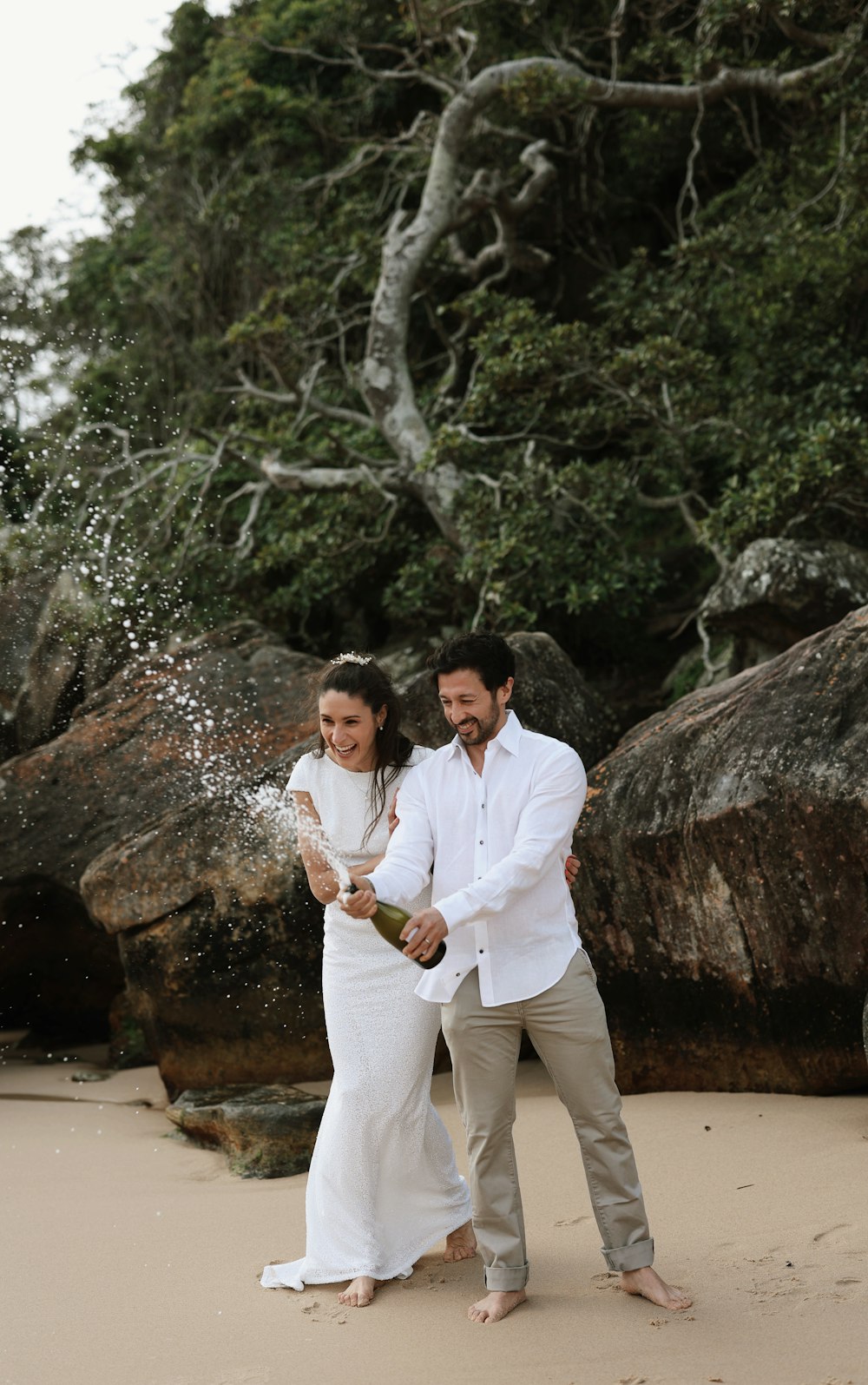 a man and a woman standing on a beach