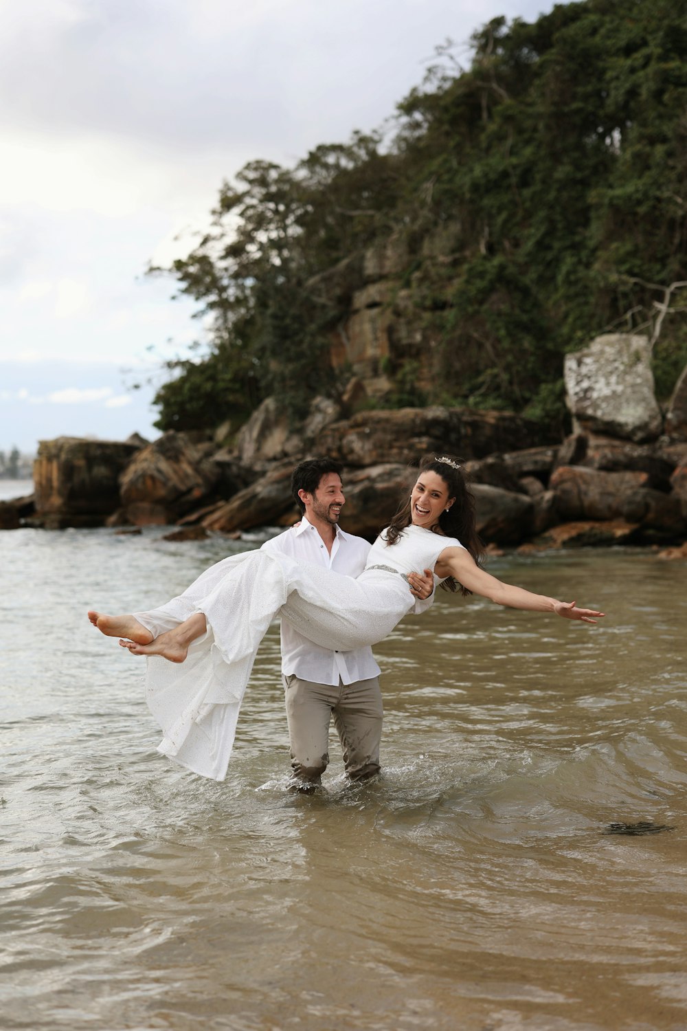 a man holding a woman in the water