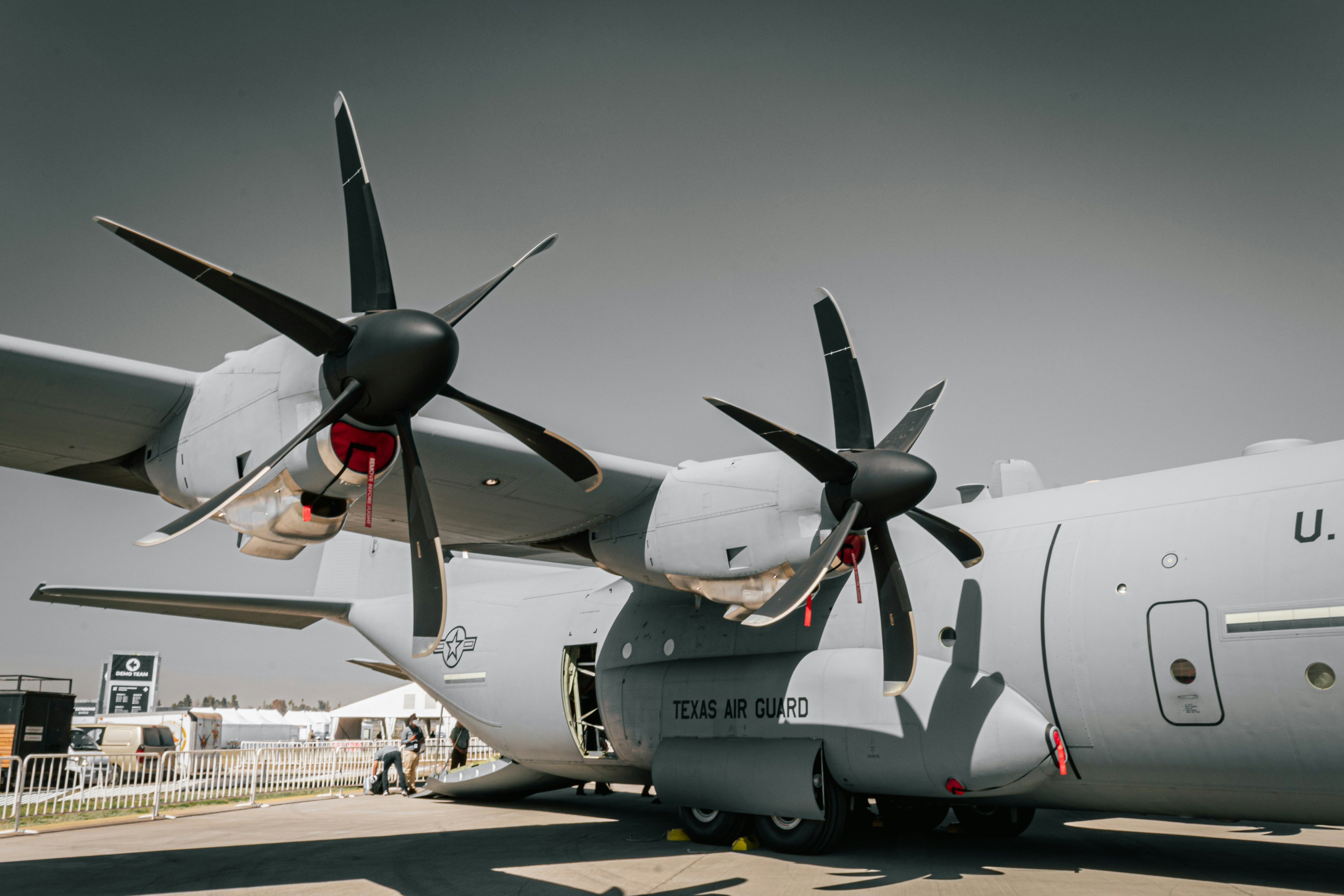 a large air plane sitting on top of an airport tarmac, 