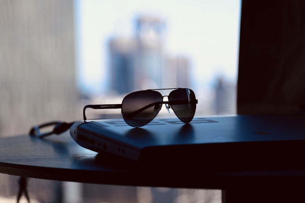 a pair of sunglasses sitting on top of a book