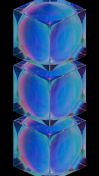 Three stacked, transparent cubes with an iridescent effect on a black background. The cubes exhibit a range of colors including blue, green, and pink, creating a holographic appearance. Each cube appears to reflect and refract light.
